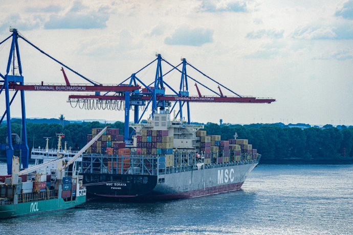Container ship being loaded at a busy port